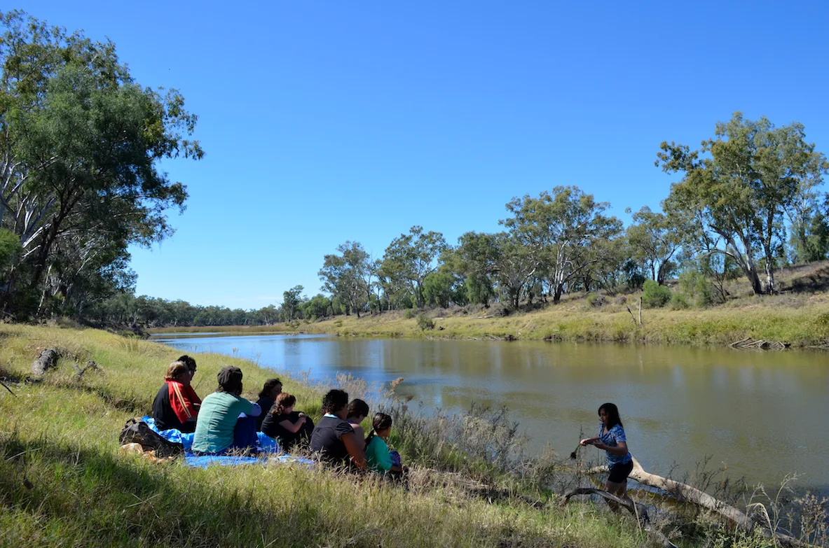The Yumba- Gunggari families talk about the significance of the river while the paper soaks in the river.